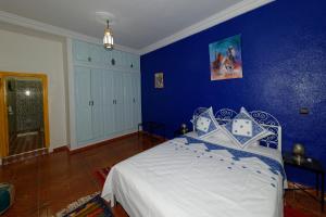 Postel nebo postele na pokoji v ubytování Riad Parfums de OUARZAZATE
