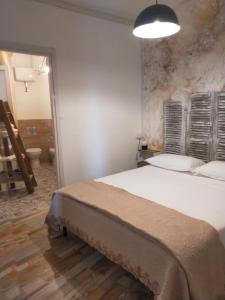 a bedroom with a large bed and a bathroom at BnB La Casina dei Nonni in Campofilone
