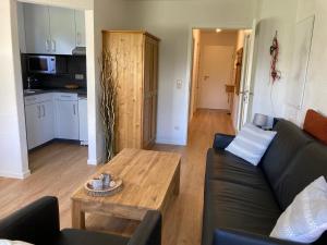 a living room with a couch and a table at Ferienwohnung Allgäublick Regina in Bad Hindelang