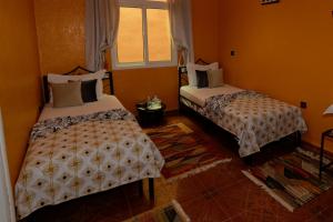 Postel nebo postele na pokoji v ubytování Riad Parfums de OUARZAZATE