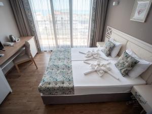 Postel nebo postele na pokoji v ubytování Cristiani Hotel Sozopol