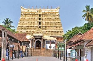 a large building in the middle of a street at Hotel Sunday - Townhouse Club Airport Trivandrum in Trivandrum