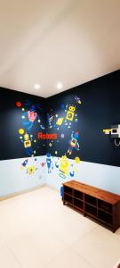 a room with a wall with a mural of robots at KLCC Amazing Robots Homestay 4Bedrooms (13pax) in Kuala Lumpur