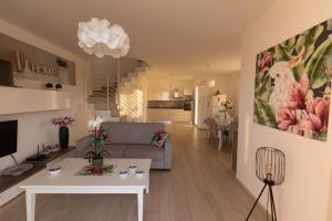 a living room with a couch and a table at Villa Cristina - Relax - Piscina e Vista Mare in Castellammare del Golfo