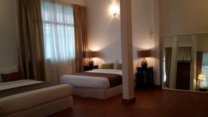 Ένα ή περισσότερα κρεβάτια σε δωμάτιο στο Beach Front Bungalow Tanjung Bungah