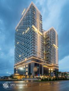 a large tall building with lights on it at Mandala Hotel & Spa Phú Yên in Tuy Hoa