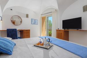 a room with a bed with a tray of food on it at Villetta Azzurro - SHERDENIA Luxury Apartments in Santa Marinella