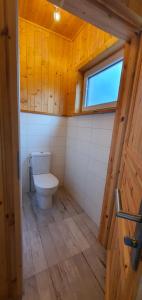 a bathroom with a toilet in a wooden house at Haus an der Pferdekoppel am Blankenburger See in Blankenburg Oberuckersee +32 photos