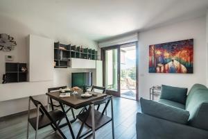 a living room with a table and a couch at JOIVY Luxury flat & Lake Como view in Argegno