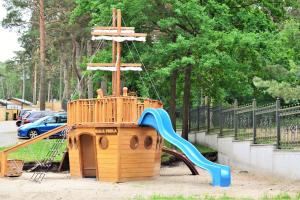 a playground with a slide in a park at Apartament Teresa Krynica Morska in Krynica Morska