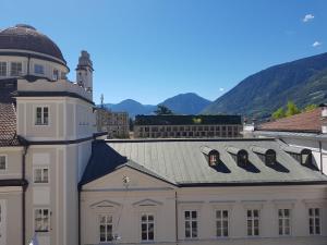 a building with a clock on the top of it at Hager Apartment 3 in Merano