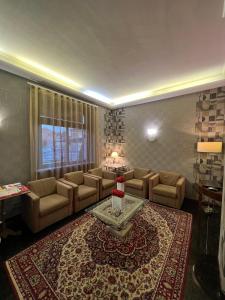 a living room with a couch and a table at Hotel La Pace in San Mauro Torinese