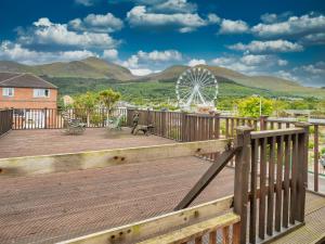 a deck with a view of a ferris wheel at The Views Townhouse in Newcastle