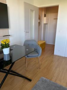a desk and a chair in a room at Panoramic View Studio - 15 min from Paris in Joinville-le-Pont