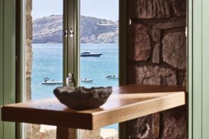 a bowl on a table in front of a window at Ninos Houses in Provatas