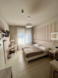 Postel nebo postele na pokoji v ubytování Hotel La Pace