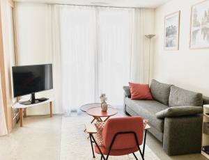 ein Wohnzimmer mit einem Sofa und einem Tisch in der Unterkunft modern, gemütlich & zentral - 3.5 Zimmerwohnung in Flims