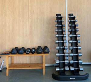 a rack of dumbbells on top of a wooden table at Hotel Yaramar - Adults Recommended in Fuengirola