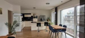 eine Küche mit einem Tisch und Stühlen sowie ein Esszimmer in der Unterkunft Luxuswohnung mit Weserblick nähe City in Bremen