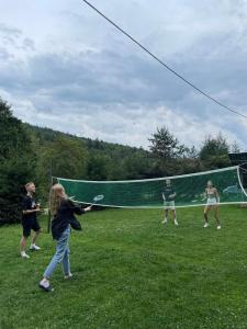 a group of people playing a game of volleyball at Bieszczadzki Klin BKLIN in Cisna