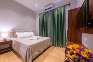 A bed or beds in a room at Casa Maria Hotel