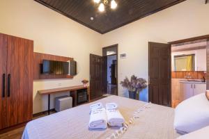 A bed or beds in a room at Casa Maria Hotel