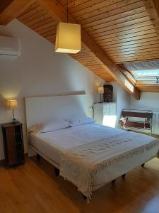 a bedroom with a large bed with a wooden ceiling at El Mirador de la Sierra in Benaocaz