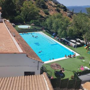 貝瑙卡斯的住宿－El Mirador de la Sierra，大型游泳池的顶部景色,里面的人
