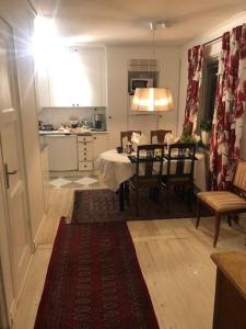 a kitchen and dining room with a table and chairs at B&B på Frösön in Östersund