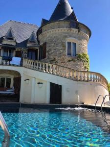 a house with a pool of water in front of it at Beautiful Château with Private Pool near Cahors in Cambayrac