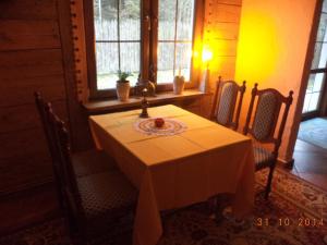 a dining room with a table and two chairs at Pensjonat Leśny Dworek in Hajnówka