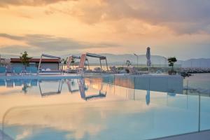 an empty swimming pool with a playground at Mount Athos Resort in Ierissos