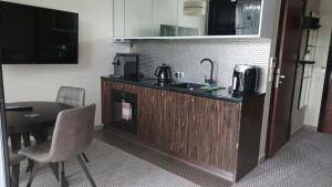 a kitchen with a sink and a fireplace in a room at Apartament z aneksem, Diune, nr 328, Kołobrzeg, blisko morza in Kołobrzeg