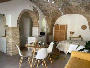 a bedroom with a bed and a table and chairs at Residenze Aimone in Vasto
