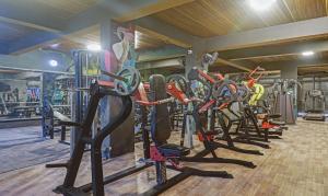 a gym with a row of treadmills and machines at Treebo Trend Seventh Heaven Kukatpally in Hyderabad