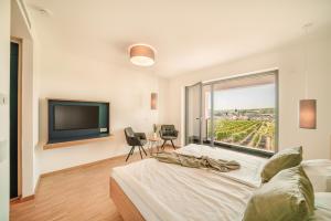 a bedroom with a large bed and a tv at Zeit bei Sauerweins in Palzem