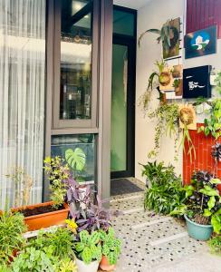a porch with potted plants in front of a building at Yi Piao B&B in Zhushan