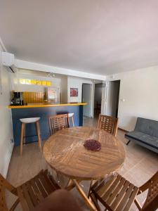 a dining room with a wooden table and chairs at Residence Bel'Soleil in Sainte-Anne