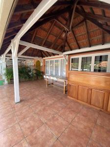 a large covered patio with a wooden ceiling at Residence Bel'Soleil in Sainte-Anne