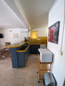 a kitchen with a counter and a sink in it at Residence Bel'Soleil in Sainte-Anne