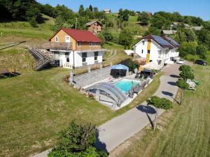 an aerial view of a house with a swimming pool at Three Stars Luxury House ART-PE with pool and SPA pool in Trebnje