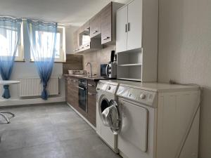 a kitchen with a washing machine and a washer at Kaiserswerth in Düsseldorf