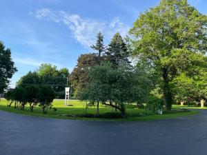 an empty parking lot with trees in a park at Nightshade Inn & Gardens in Camillus