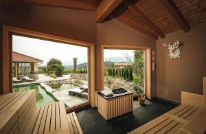 a room with a large window and a view of a yard at Wellness Natur Resort Gut Edermann in Teisendorf