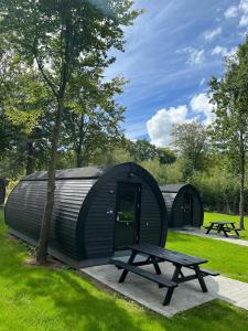 a circular building with a picnic table in a park at SportsPark Blaavandshuk Resort in Oksbøl