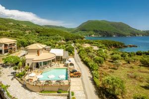 an aerial view of a house with a swimming pool at 3Aktes Suites & Studios in Syvota