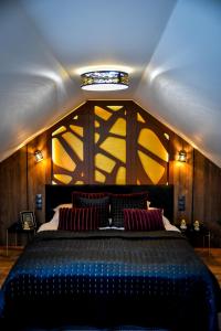 a bedroom with a large blue bed with a ceiling at Meru Minivilla in Szeged