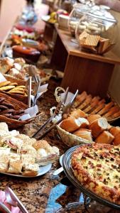 a table topped with lots of different types of food at Pousada Condado Brasileiro in Campos do Jordão