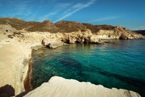 an aerial view of a beach with blue water at Kampaoh Los Escullos in Almería