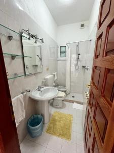 a white bathroom with a sink and a toilet at Villa Loreta in Ischia